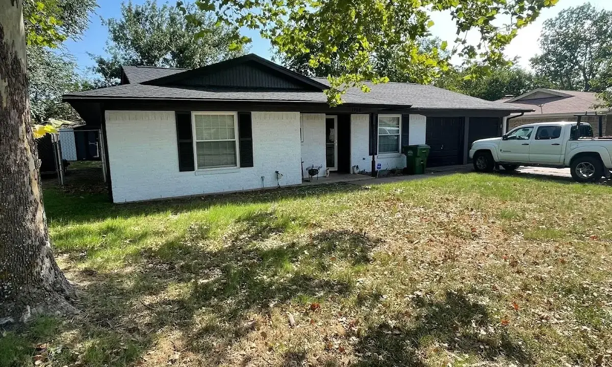 Professional roofing crew working on a residential roof in Mack